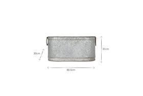 The Akasa Trough Planter by nkuku features a galvanized zinc oval design with ribbed texture, two round side handles, and a weathered finish. One side measures 30 cm tall, the other 31 cm, with an overall width of 60.5 cm against a white background.
