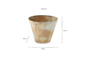 The nkuku Abari Tapered Planter features an aged zinc finish and flares outward from a small base. Labeled “Medium,” it measures 41cm high by 50cm wide at the top, with arrows marking its dimensions.