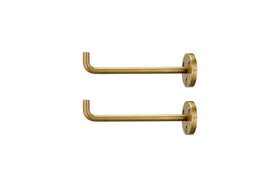 The nkuku Aniko Iron Hook - Brass (Set of 2) features two identical wall-mounted hooks with a round plate, three screw holes, and a straight arm with an upturned end—ideal for stylish wall storage. Shown against a white background.