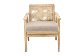 The Atri Mango Wood & Cane Occasional Chair by nkuku features a sustainable mango wood frame, woven cane backrest, beige upholstered cushion, and straight legs for a minimalist modern look. Shown on a plain white background.