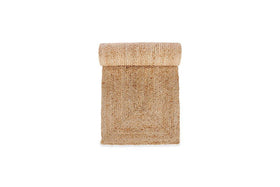 The nkuku Braided Hemp Table Runner features coarse, woven natural fibers in a beige-tan hue, offering handcrafted style—ideal for adding rustic charm to your tablescape. Shown rolled on a white background.