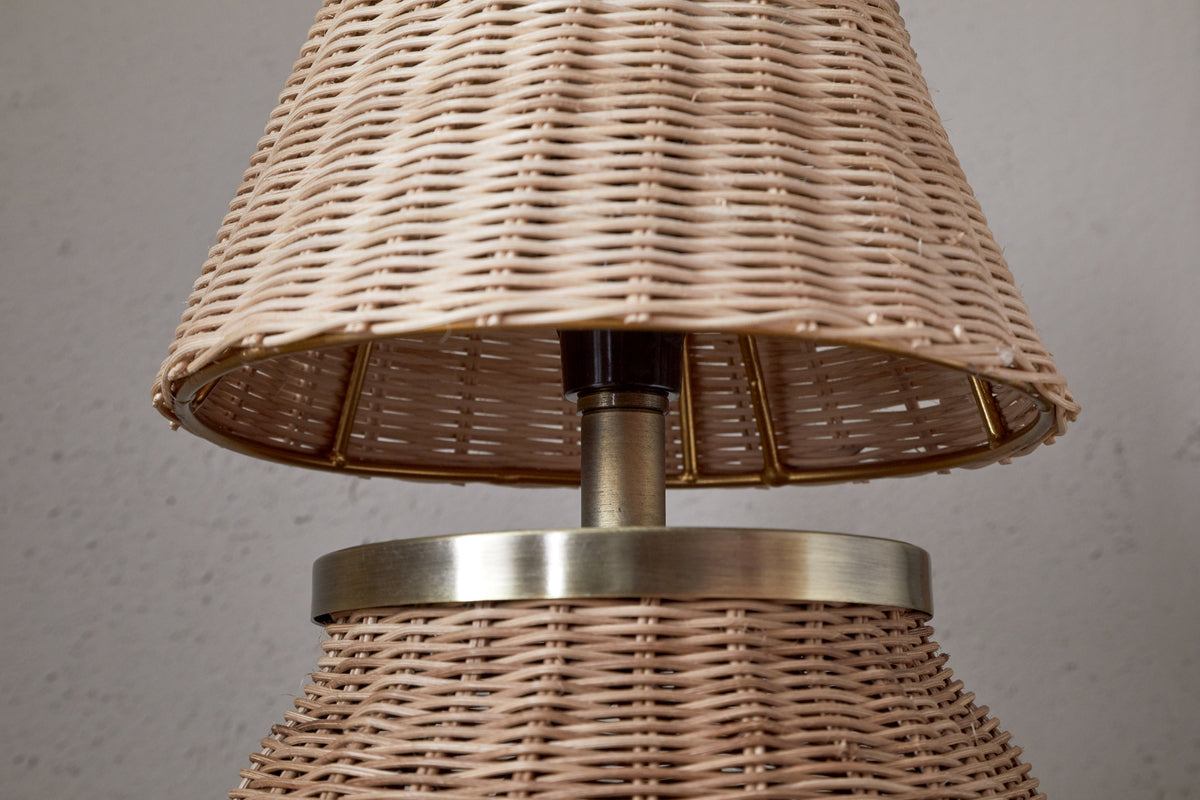 The Cija Rattan Table Lamp by nkuku features a natural woven shade and base, accented with a metallic band and stem—perfect for adding style to any bedside table.
