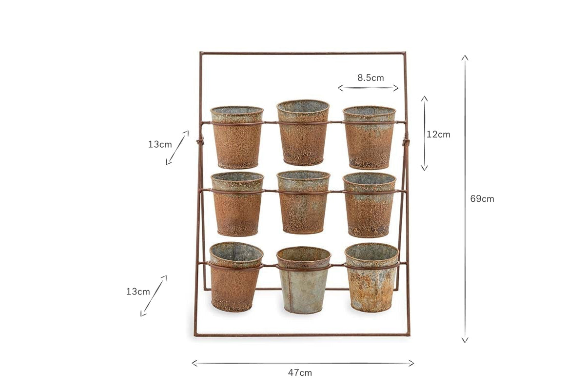 The nkuku Abari Planter Stand holds nine aged zinc pots in three rows. Measuring 69 cm tall and 47 cm wide, its rustic, distressed finish makes it ideal vintage-style garden decor.