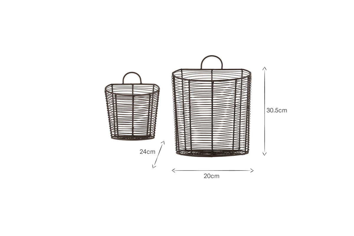 The Inkollu Wall Hung Baskets by nkuku (set of 2) in aged brass are shown. The smaller basket is 24cm tall; the larger is 30.5cm tall and 20cm wide. Both have handles and an open, cylindrical design for wall display.