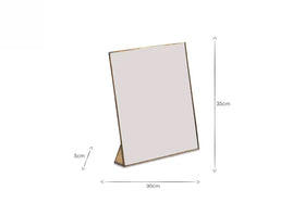 A rectangular tabletop mirror with a slim gold frame (35 cm tall, 30 cm wide, 5 cm stand) stands upright on a white background—perfect placed beside nkuku’s Karuma Ceramic Mug - Small (Set of 2) or other handmade mugs.