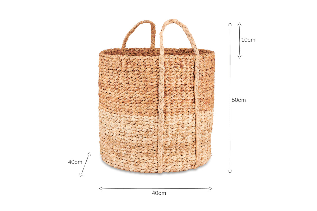 The nkuku Nkomi Basket is a handwoven natural storage basket with two handles and three beige bands, measuring 50cm tall by 40cm wide and deep, inspired by traditional Nkomi baskets.