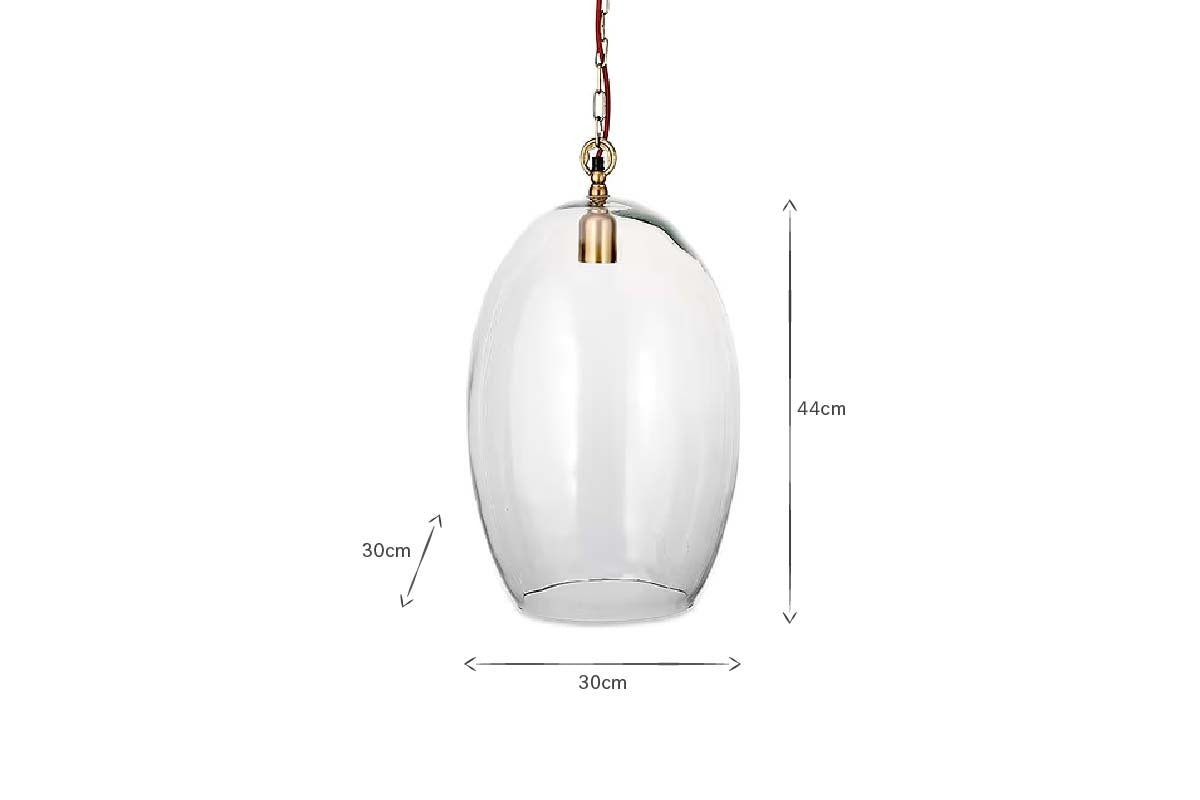 The Otoro Recycled Glass Pendant - Clear - Small Oval by nkuku features an oval-shaped recycled glass shade, brass fittings, and hanging chain. Measuring 44 cm high and 30 cm wide, it's a stylish choice for elegant lighting in any room.