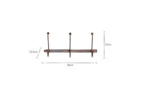 The nkuku Rama Iron Hook rack features three evenly spaced iron hooks on a 34 cm wide bar, each hook standing 15 cm tall. Measurements are clearly marked with arrows and labels for easy reference—a stylish hallway storage solution.