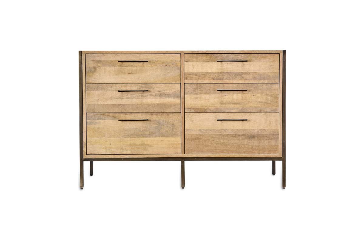 The Dasai Mango Wood Chest of Drawers by nkuku features six light mango wood drawers with slim handles, set in a dark metal frame and thin legs—a stylish and modern choice for any bedroom.