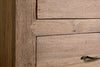 Close-up of the nkuku Iya Reclaimed Wood Chest of Drawers – Natural – Small, showing unique grain texture, two drawers, and a simple metal handle on the lower drawer.