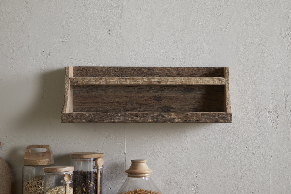 The nkuku Ibo Reclaimed Wood Storage Shelf - Natural brings rustic charm and practical kitchen storage to any space with its weathered wood design and wall-hung style.