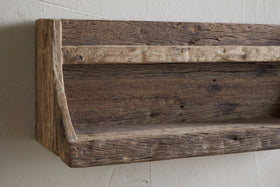 The nkuku Ibo Reclaimed Wood Storage Shelf - Natural adds charm and extra kitchen storage to any wall with its rustic, wall-hung design made from weathered wood.