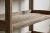 Close-up of the nkuku Ibo Reclaimed Wood Pantry Standing Shelves in Natural, showcasing their rustic, weathered finish and striking wood grain against a light wall—ideal for open shelving in any kitchen or pantry.
