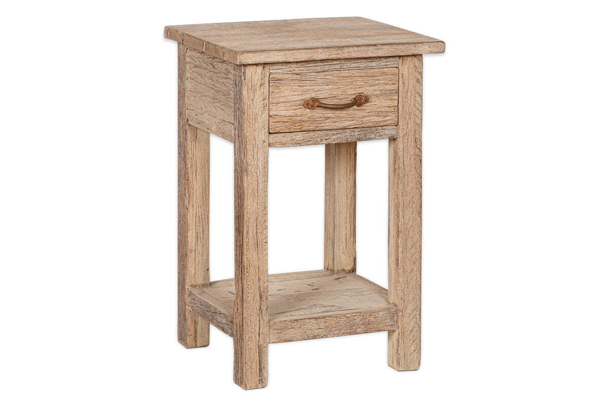 The Ibo Reclaimed Wood Bedside Table - Natural from nkuku is a compact, rustic table with visible wood grain, a rope-handled drawer, open shelf, and straight legs. Its weathered finish and sturdy design add charm to any space.