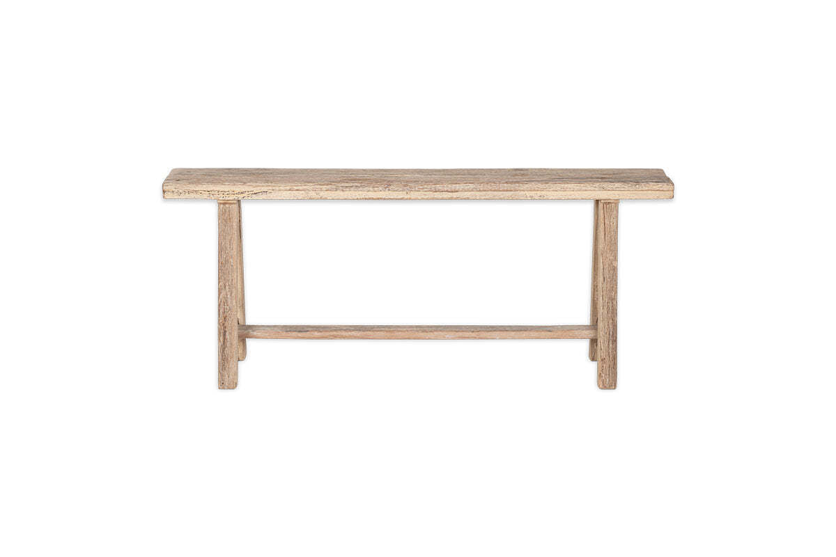 The nkuku Ibo Reclaimed Wood Long Bench - Natural has a rectangular seat, straight legs, and a support bar, all in a rustic natural finish. It’s shown on a plain white background for a clean, timeless look.