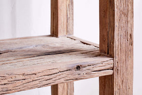 Close-up of the nkuku Ibo Reclaimed Wood Shelf - Natural - Wide, showcasing its rustic design, weathered wood grain, and distinctive knot details on the reclaimed wood shelf and frame.