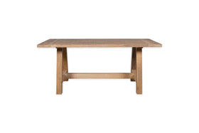 The nkuku Indali Mango Wood Dining Table - Natural features a rectangular, weathered mango wood top and sturdy tapered legs with a lower stretcher—an ideal sustainable choice for cozy spaces.