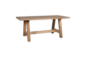 The nkuku Indali Mango Wood Dining Table - Natural features a thick rectangular top and sturdy trestle legs joined by a support beam, showcasing simple, rustic design and sustainable mango wood on a plain white background.