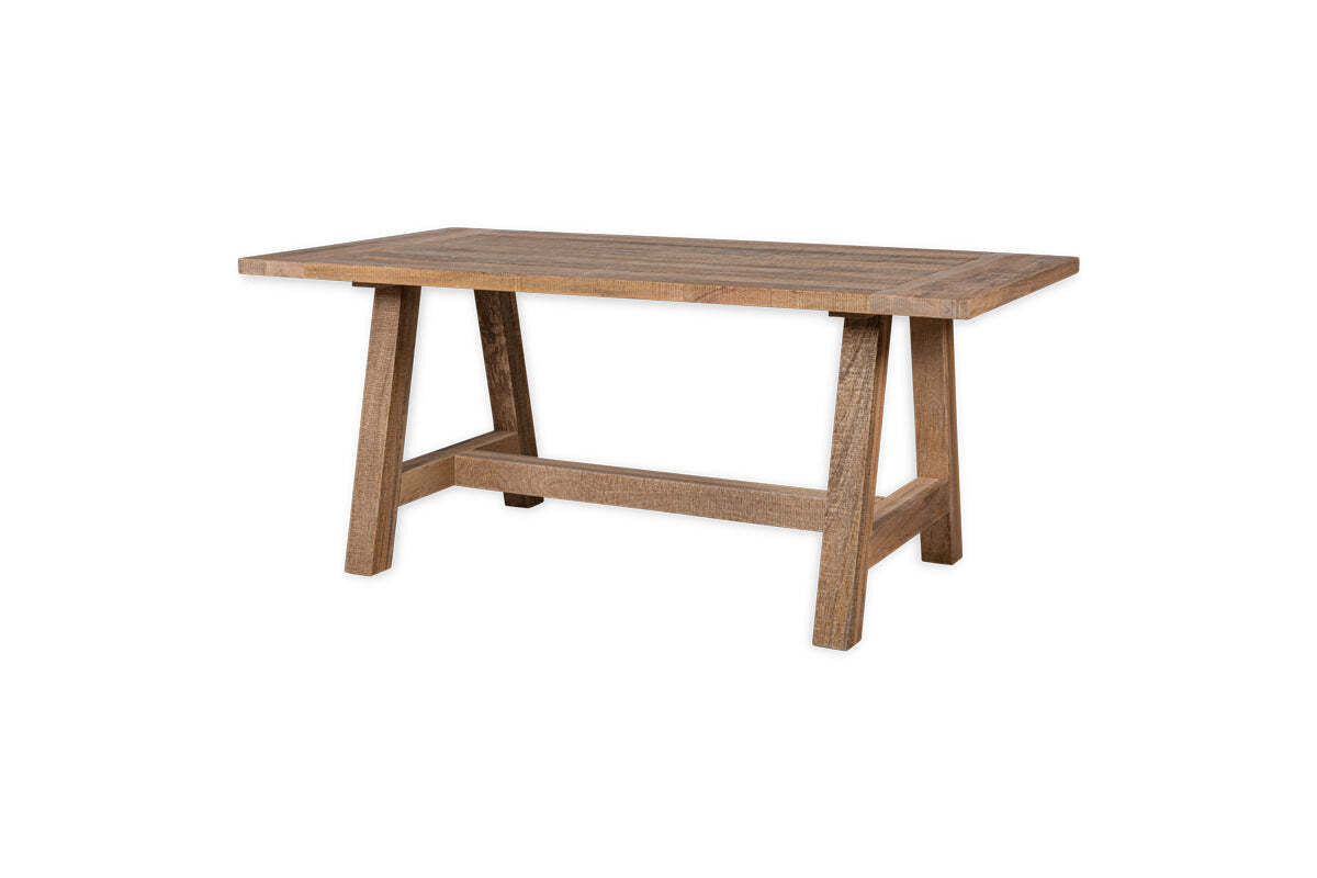 The Indali Mango Wood Dining Table by nkuku features a rectangular shape, natural mango wood with a rustic finish, a thick top, and sturdy angled legs with matching horizontal supports. The table is shown isolated on a white background.