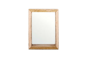The Indu Standing Mango Wood Frame - Natural by nkuku features a rectangular design with a natural mango wood finish that showcases the grain. Its clean mirror surface beautifully complements the sustainable frame against a plain white background.