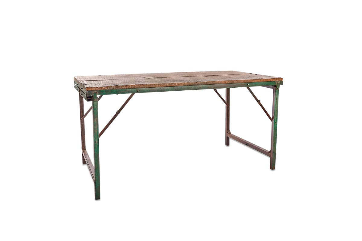 The Ishan Reclaimed Folding Dining & Coffee Table by nkuku features a weathered wooden top with visible screws and green metal legs showing rust, highlighting its vintage charm against a simple white background.