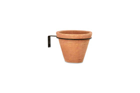 The nkuku Jara Single Wall Hung Planter features a round terracotta pot in a flat black metal ring bracket with a right-angle design and two screw holes for easy mounting. Displayed against a plain white background.