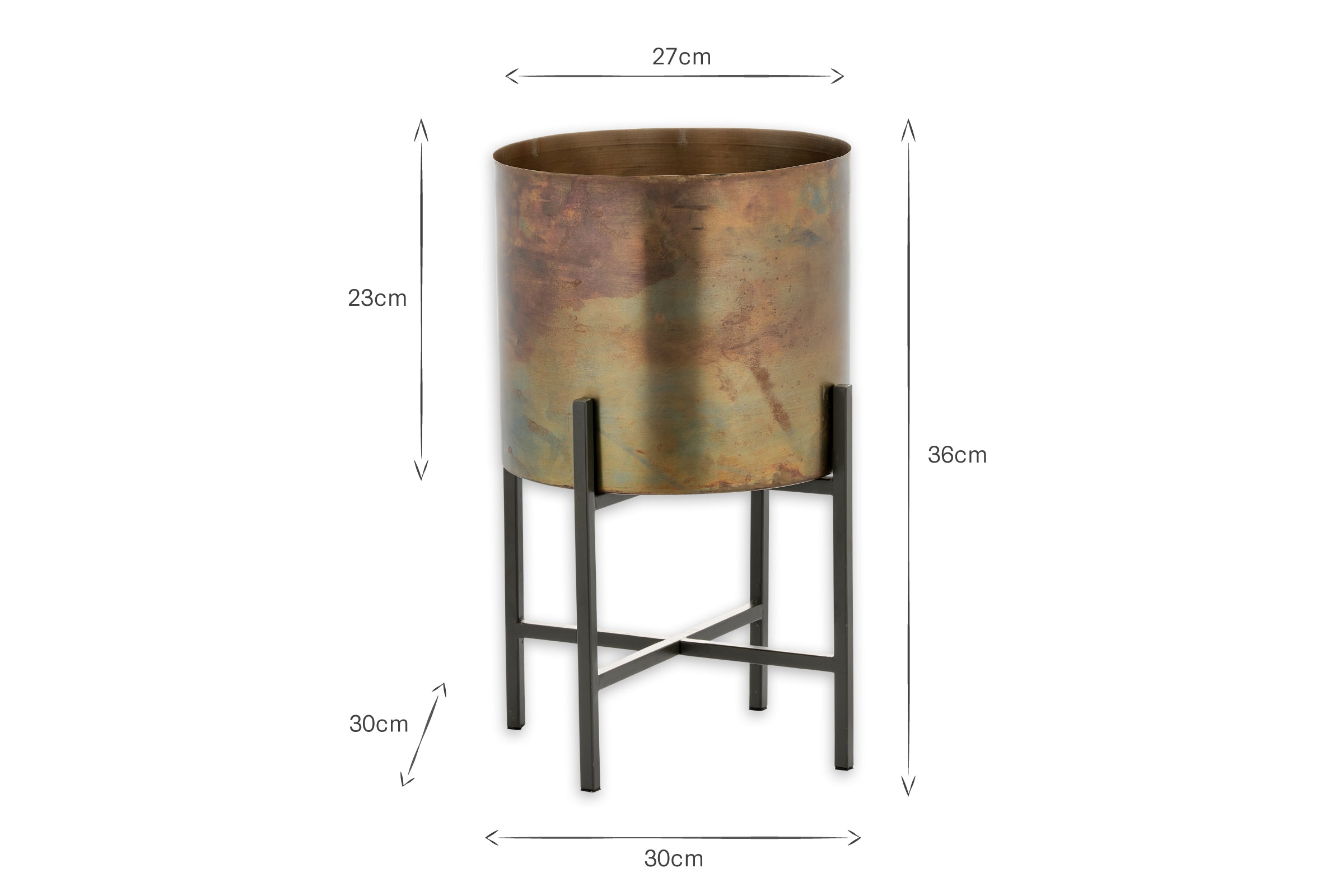The Juoni Iron Planter by nkuku features a metallic cylindrical design with a bronze finish and sits on a black metal stand with four legs and crossbars. Ideal for house plants, it measures 23cm high, 27cm wide, and 36cm tall including the stand.