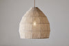 The nkuku Jahari Woven Jute Pendant - Natural features a dome-shaped, natural fibre shade that hangs elegantly from the ceiling, casting a warm, textured glow perfect for adding rustic charm to any light-colored space.