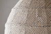 Close-up of the nkuku Jahari Woven Jute Pendant in Natural, featuring a dome-shaped design with coarse, woven burlap for visible texture—ideal for adding rustic charm to any home decor.