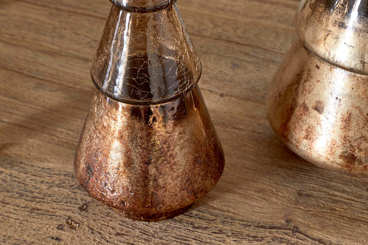 The Konara Glass Tree by nkuku features a gold crackle finish, creating a striking accent piece. Its metallic sheen and unique texture make it perfect for adding festive charm to any space or table setting.