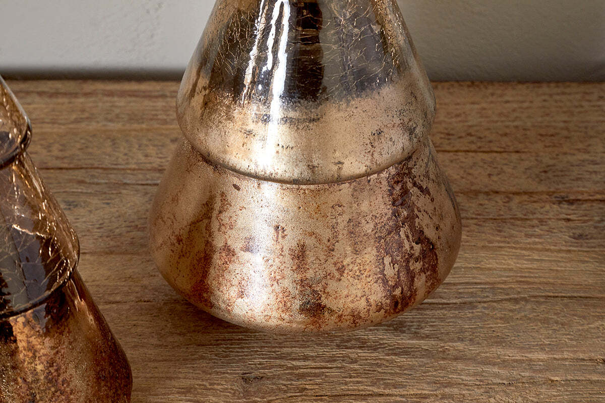 The Konara Glass Tree - Gold Crackle by nkuku features a metallic cone shape with a wide base and distressed gold, bronze, and brown finish. Its shimmering surface makes it ideal as festive décor or a vintage-inspired accent piece.