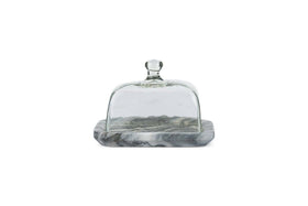The nkuku Kallso Marble Butter Dish features a smooth, polished rectangular marble base with elegant gray marbling and a recycled clear glass dome lid with a round knob, displayed on a white background.
