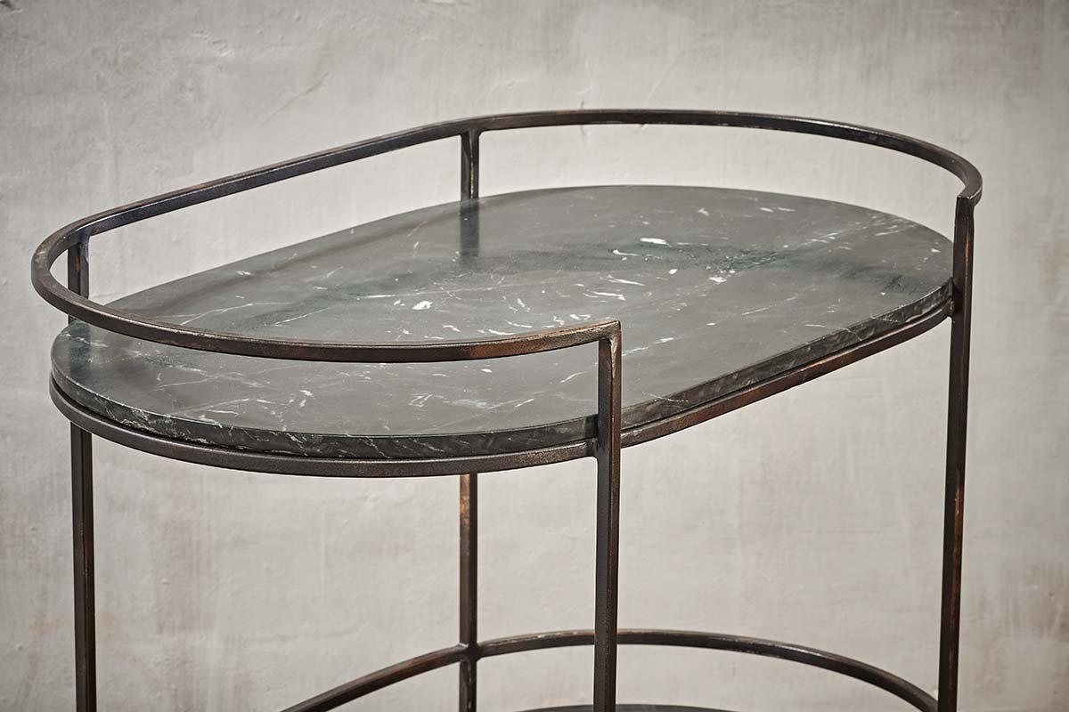 The Karoko Marble Drinks Table by nkuku features an oval black marble top with white veining, slim black metal legs, and a matching rim—a minimalist standout for entertaining in modern spaces.