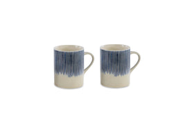 The nkuku Karuma Ceramic Mug - Large (Set of 2) features handmade mugs with handles and a vertical blue stripe design fading into a cream base, displayed on a plain white background.