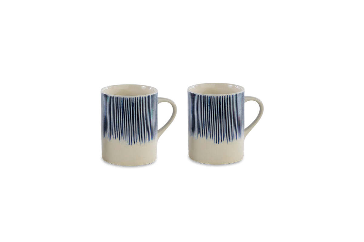 The nkuku Karuma Ceramic Mug - Large (Set of 2) features handmade mugs with handles and a vertical blue stripe design fading into a cream base, displayed on a plain white background.