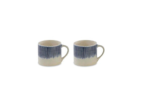The Karuma Ceramic Mug - Small (Set of 2) by nkuku features two cream-colored, handmade Vietnamese mugs adorned with thin dark blue vertical lines that fade towards the base.