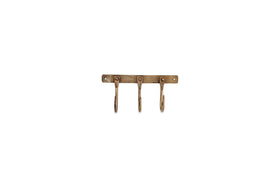 The nkuku Kuna Iron Hooks - Antique Brass features three vintage, curved iron hooks on a rectangular wall-mounted base with two visible screw holes, ideal for adding stylish, small storage to any space.