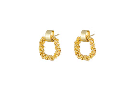 The nkuku Mula Earrings - Gold feature circular hoops made of clustered, faceted brass beads, attached to matte gold cylindrical posts. Their elegant, textured design is showcased on a plain white background.