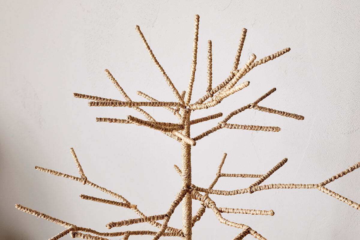 The nkuku Mala Base Jute Tree - Natural features many thin, woven jute branches and a minimalist leafless design, making it a textured, simple decor piece against any plain wall—perfect for festive decorating.