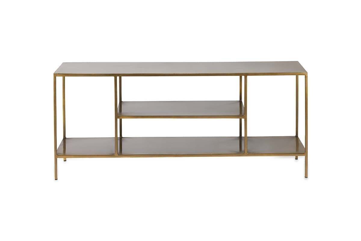 The Mahi Media Standing Shelf by nkuku features a slim gold metal frame and three rectangular wooden shelves, including two open brass shelves in the center, ideal for organizing entertainment equipment. Photographed against a plain white background.