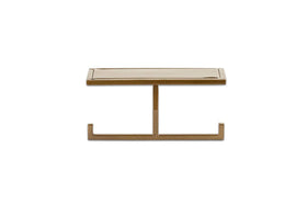 The nkuku Mahi Wall Mounted Toilet Roll Holder has a sleek, minimalist brass design with a slim top and central support on two horizontal feet, shown against a plain white background.