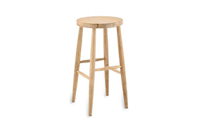 The Mengwi Mango Wood Round Bar Stool - Natural by nkuku is crafted from sustainable mango wood, featuring a light-toned seat and four tapered legs with horizontal supports for added stability.