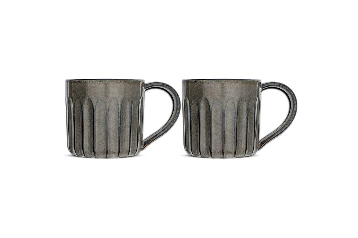 The Moda Mug - Pewter (Set of 2) by nkuku features two gray ceramic mugs with vertical ribbed texture, large rounded right handles, and glossy finish—all shown side by side against a white background.