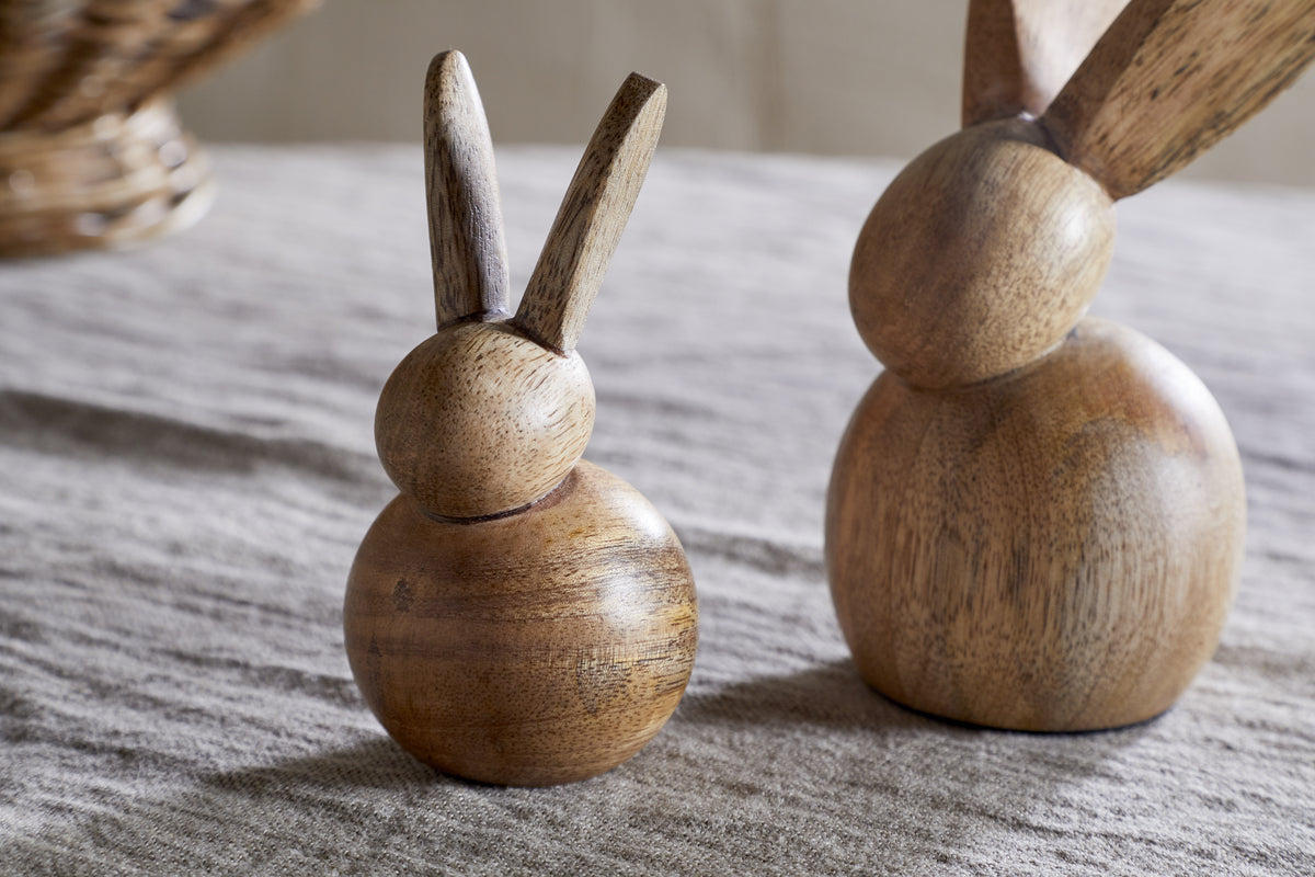 The nkuku Khara Mango Wood Rabbit Standing Decoration features two charming bunny silhouettes with visible wood grain and a smooth, natural finish—perfect for Easter décor or adding a nature-inspired touch to your space.