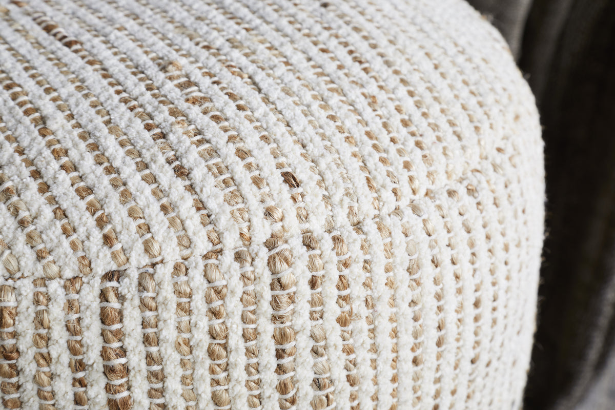 Close-up of the Zairya Jute & Cotton Tall Pouf by nkuku in natural and rust, featuring a textured, woven grid pattern with thick cream, tan, and rust threads—perfect for home decor or as sturdy furniture upholstery.
