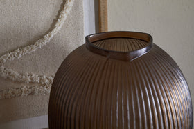 The nkuku Linsy Ribbed Glass Vase in Smoke Brown features elegant ribbing and a stylish smoked finish.