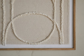 The Mauri Frayed Wall Art - Neutral by nkuku features cream-colored raised lines forming geometric shapes, including a large circle intersected by vertical lines, on a beige canvas. This neutral wall decor is wood-framed for a modern touch.