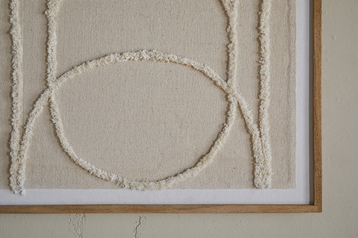 The Mauri Frayed Wall Art - Neutral by nkuku features cream-colored raised lines forming geometric shapes, including a large circle intersected by vertical lines, on a beige canvas. This neutral wall decor is wood-framed for a modern touch.