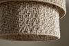 Close-up of the nkuku Thimba Woven Jute Chandelier in Natural, featuring a textured jute shade with intersecting fibers. The rustic weave allows gentle light to filter through, highlighting its organic charm.