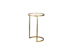 The Nakuru Iron & Glass Side Table Set by nkuku features a modern brass design with a round white glass top and slim gold frame. Its open C-shaped base adds minimalist style, making it perfect for chic living spaces.